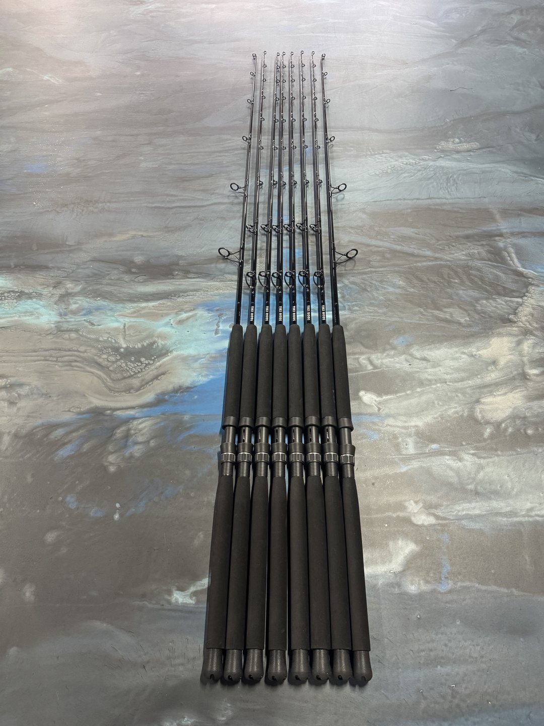 An all-black matched set fanned tip to butt across the marbled work table