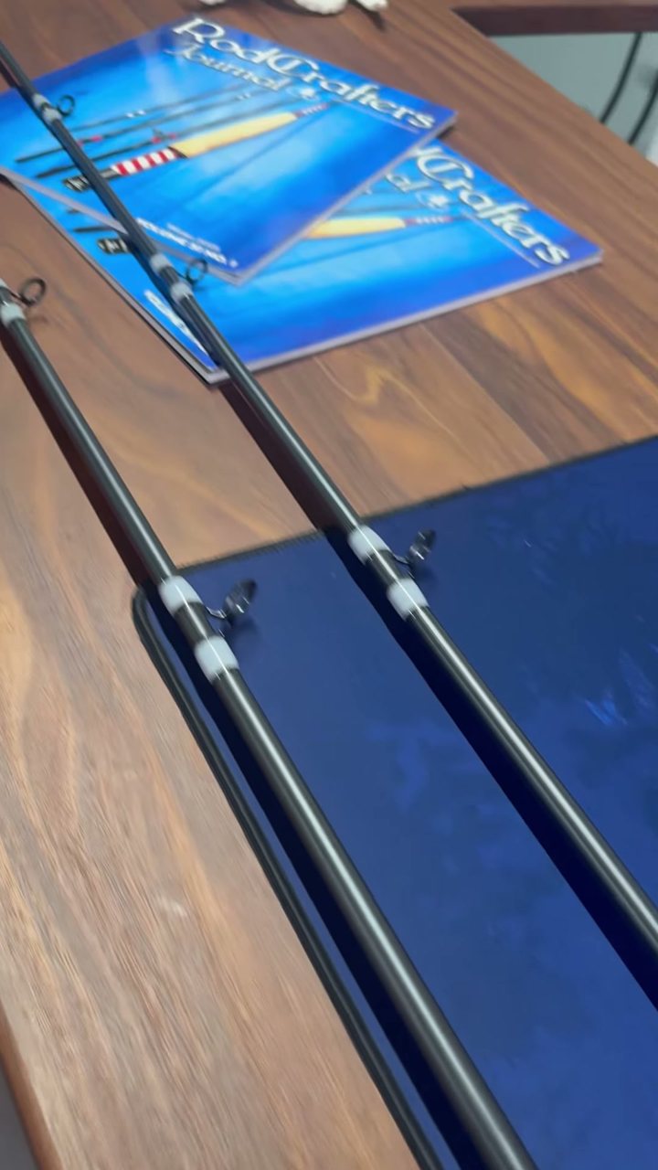 Two finished rods resting on the bench mat next to their component packaging