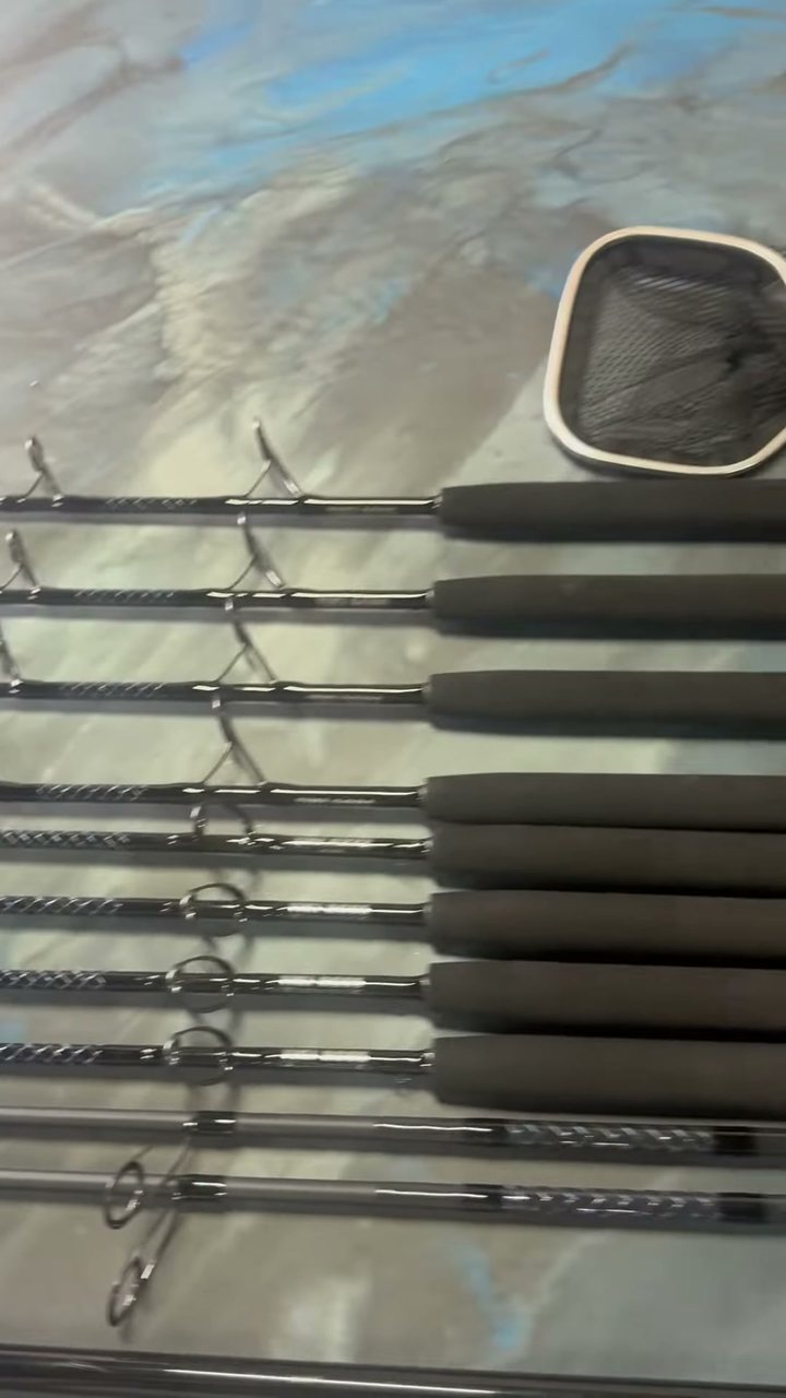 Heavy offshore rods with oversized guides and foam grips waiting on the bench