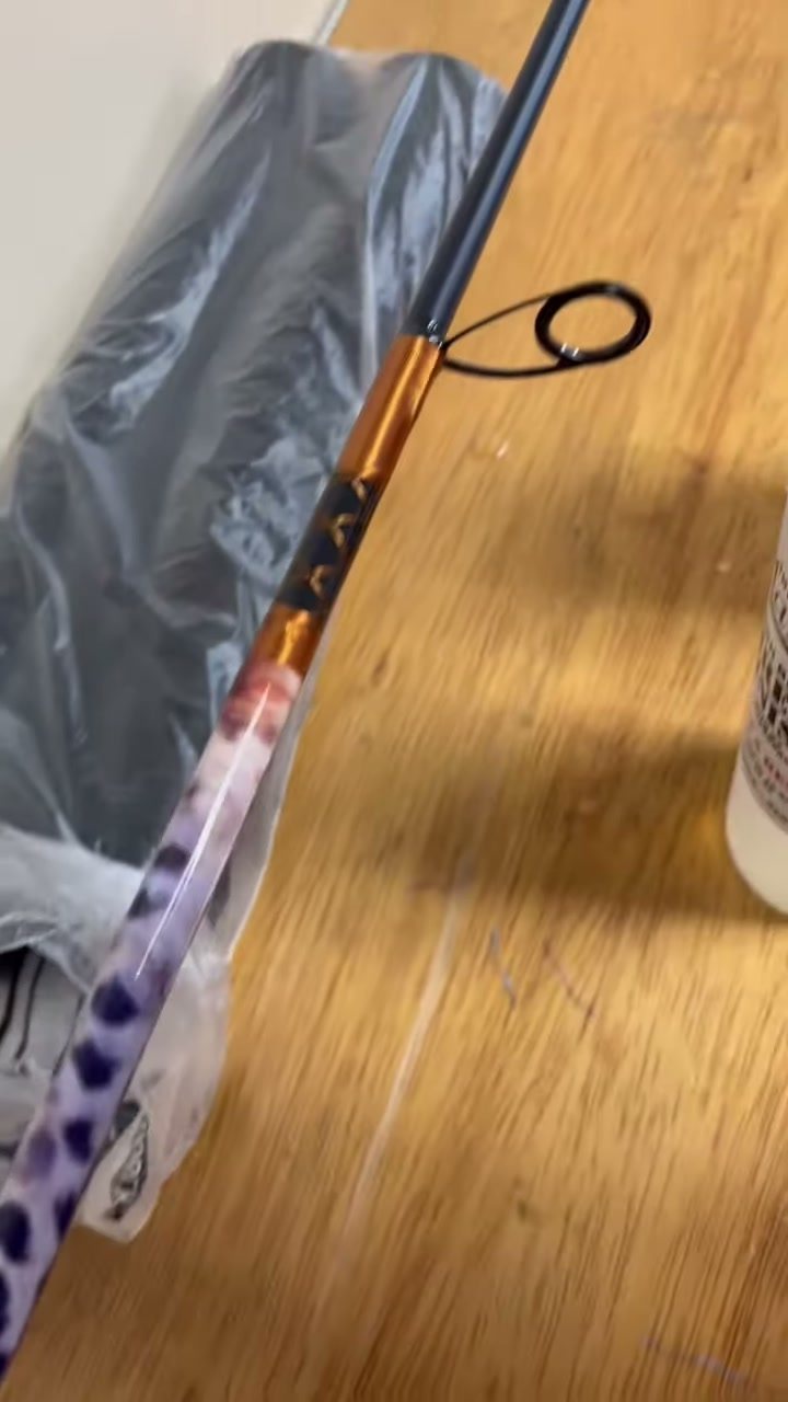 A purple leopard marbled butt section with an orange trim band, bagged and ready to go out