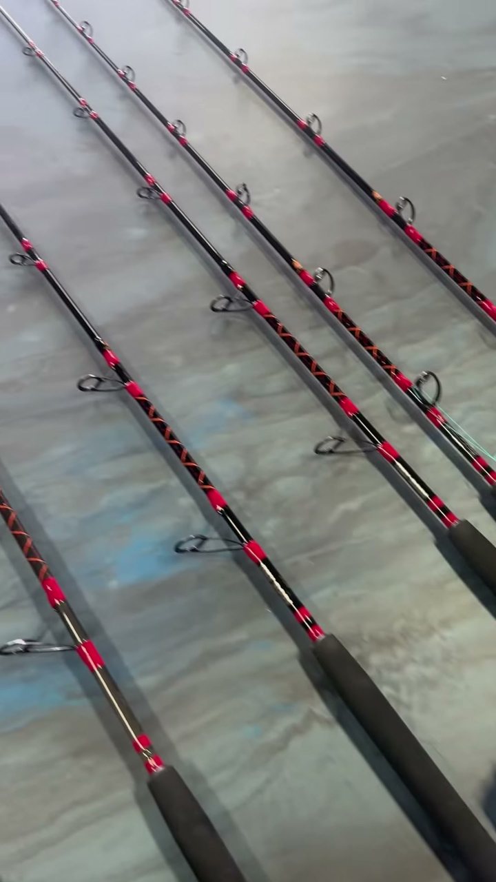 Red-wrapped offshore setups fanned across the marbled bench